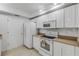 Bright kitchen featuring white cabinets, modern appliances, and a tile floor at 5300 S Atlantic Ave # 9-206, New Smyrna Beach, FL 32169