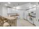 Bright kitchen features white cabinetry, a breakfast bar, and modern appliances at 5300 S Atlantic Ave # 9-206, New Smyrna Beach, FL 32169