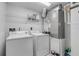 Efficient laundry room equipped with washer, dryer, and storage shelves at 5300 S Atlantic Ave # 9-206, New Smyrna Beach, FL 32169