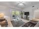 Cozy living room with balcony access and comfortable seating at 5300 S Atlantic Ave # 9-206, New Smyrna Beach, FL 32169