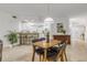 Open concept living space featuring a dining area, modern lighting, and a view into the kitchen at 5300 S Atlantic Ave # 9-206, New Smyrna Beach, FL 32169