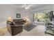 Comfortable living room with balcony access and natural light at 5300 S Atlantic Ave # 9-206, New Smyrna Beach, FL 32169