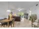 Spacious living room with dining area, balcony access, and stylish decor at 5300 S Atlantic Ave # 9-206, New Smyrna Beach, FL 32169