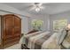 Comfortable main bedroom suite with a large bed and a view to the balcony and the yard at 5300 S Atlantic Ave # 9-206, New Smyrna Beach, FL 32169
