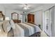 Well lit main bedroom with a large window and door with access to the balcony and yard at 5300 S Atlantic Ave # 9-206, New Smyrna Beach, FL 32169