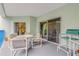 Large covered patio with outdoor seating and access to the indoors through sliding glass doors at 5300 S Atlantic Ave # 9-206, New Smyrna Beach, FL 32169