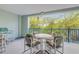 Covered patio features seating and scenic views of lush greenery beyond the blue railing at 5300 S Atlantic Ave # 9-206, New Smyrna Beach, FL 32169