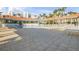 Relaxing pool area with tiled patio, covered lounge area, and palm trees, perfect for relaxing and socializing with friends and neighbors at 5300 S Atlantic Ave # 9-206, New Smyrna Beach, FL 32169