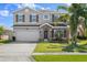 Charming two-story home features a stone-accented entrance, a two-car garage, and a well-manicured lawn at 5337 Royal Plantation Blvd, Port Orange, FL 32128