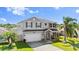 Charming two-story home with a well-maintained lawn, attached two-car garage, and beautiful stone column accents at 5337 Royal Plantation Blvd, Port Orange, FL 32128