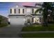 Charming two-story home with a well-manicured lawn at 5337 Royal Plantation Blvd, Port Orange, FL 32128