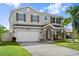 Well-maintained two-story home with a spacious driveway, a two-car garage, and neat front yard landscaping at 5337 Royal Plantation Blvd, Port Orange, FL 32128