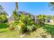 Beautifully landscaped backyard with lush greenery and a screened enclosure at 5430 Dubois Ave, Port Orange, FL 32127