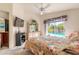 Inviting bedroom with view of pool, dresser with mirror, and mounted TV at 5430 Dubois Ave, Port Orange, FL 32127