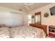 Bright bedroom with a floral comforter, ceiling fan, and wooden dresser providing ample storage at 5430 Dubois Ave, Port Orange, FL 32127