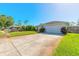 Charming home featuring a well-maintained lawn and a two-car garage with a long driveway at 5430 Dubois Ave, Port Orange, FL 32127