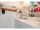 Functional laundry room with washer, dryer, and ample shelving for storage at 5430 Dubois Ave, Port Orange, FL 32127