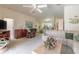 Open living space with neutral carpet and furniture, with adjacent kitchen visible at 5430 Dubois Ave, Port Orange, FL 32127