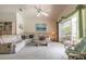 Cozy living room with comfortable seating, a ceiling fan, and sliding glass doors to the outdoors at 5430 Dubois Ave, Port Orange, FL 32127
