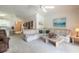 Inviting living room with neutral tones, comfortable sectional sofa, and view to kitchen at 5430 Dubois Ave, Port Orange, FL 32127