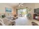 Bright living room featuring comfortable seating and sliding glass doors leading to a pool area at 5430 Dubois Ave, Port Orange, FL 32127