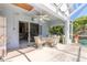 Covered patio with wicker seating, perfect for outdoor relaxation and dining at 5430 Dubois Ave, Port Orange, FL 32127