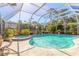 Screened pool with attached hot tub and lots of surrounding tropical foliage at 5430 Dubois Ave, Port Orange, FL 32127