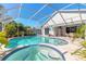 Inviting screened pool and spa surrounded by a spacious patio and lush landscaping at 5430 Dubois Ave, Port Orange, FL 32127