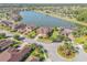 Aerial view of a beautiful lakeside community with well-manicured lawns and mature trees at 610 Mura Ct, New Smyrna Beach, FL 32168