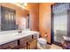 Bathroom featuring a spacious vanity, mirror, and a door with sheer curtains at 610 Mura Ct, New Smyrna Beach, FL 32168