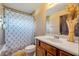 Well-lit bathroom with shower, toilet, vanity, and neutral tile at 610 Mura Ct, New Smyrna Beach, FL 32168