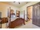 Bedroom with a four poster bed, carpeted flooring, and ensuite bath access at 610 Mura Ct, New Smyrna Beach, FL 32168