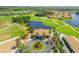 Overhead shot of the community clubhouse and golf course in a residential neighborhood at 610 Mura Ct, New Smyrna Beach, FL 32168
