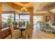 Sunlit dining area with water view, decorated chairs, and glass top table at 610 Mura Ct, New Smyrna Beach, FL 32168