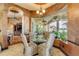 Breakfast nook with glass table, decorated chairs, and view of the lanai and pool at 610 Mura Ct, New Smyrna Beach, FL 32168