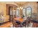 Elegant dining room with hardwood floors, arched windows, and a decorative cabinet at 610 Mura Ct, New Smyrna Beach, FL 32168