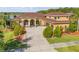 Stately two-story home with lush landscaping, a spacious driveway, and a well-maintained lawn at 610 Mura Ct, New Smyrna Beach, FL 32168