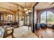 Grand foyer with decorative column and furnishings and an adjacent formal dining room at 610 Mura Ct, New Smyrna Beach, FL 32168