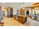 The kitchen includes wood cabinets, a central island, and stainless steel appliances at 610 Mura Ct, New Smyrna Beach, FL 32168