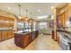 Bright kitchen featuring an island with sink and stainless appliances and large windows at 610 Mura Ct, New Smyrna Beach, FL 32168