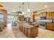Open kitchen featuring wood cabinets, stainless appliances, granite countertops, and an island with a sink at 610 Mura Ct, New Smyrna Beach, FL 32168