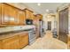 The kitchen includes wood cabinets, stainless steel appliances, and tile flooring at 610 Mura Ct, New Smyrna Beach, FL 32168