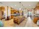 Spacious kitchen featuring wood cabinets, granite countertops and a large central island with hanging pendant lights at 610 Mura Ct, New Smyrna Beach, FL 32168