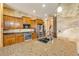 A kitchen with wood cabinets, stainless appliances, a large granite countertop and tile floors at 610 Mura Ct, New Smyrna Beach, FL 32168