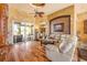Bright living room showcasing hardwood floors, comfortable seating, and elegant decor with access to patio at 610 Mura Ct, New Smyrna Beach, FL 32168