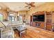 Spacious living room features hardwood floors, stylish furniture, and a decorative ceiling fan at 610 Mura Ct, New Smyrna Beach, FL 32168