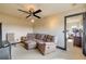 Spacious living room featuring comfortable seating, a ceiling fan, and plush carpeting at 610 Mura Ct, New Smyrna Beach, FL 32168