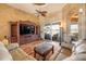 Living room showcasing a decorative fan and hardwood flooring with a large glass sliding door at 610 Mura Ct, New Smyrna Beach, FL 32168