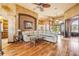 Inviting living room boasting hardwood floors, a plush sectional, and access to other areas of the home at 610 Mura Ct, New Smyrna Beach, FL 32168