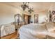 Elegant Primary bedroom with hardwood floors, ornate furniture, and dual ceiling fans at 610 Mura Ct, New Smyrna Beach, FL 32168